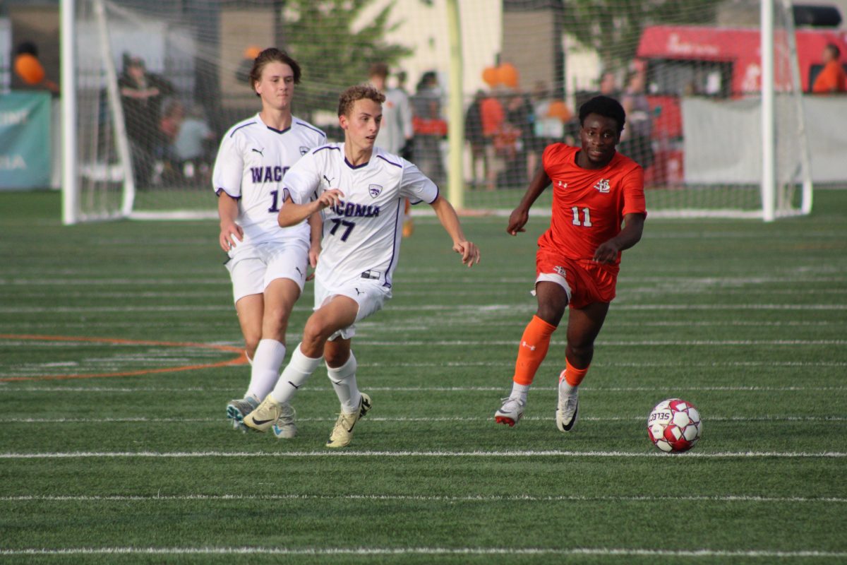 Senior Gael Miteo runs past defenders from Waconia Sept. 18. Park beat the Wildcats 3-1.