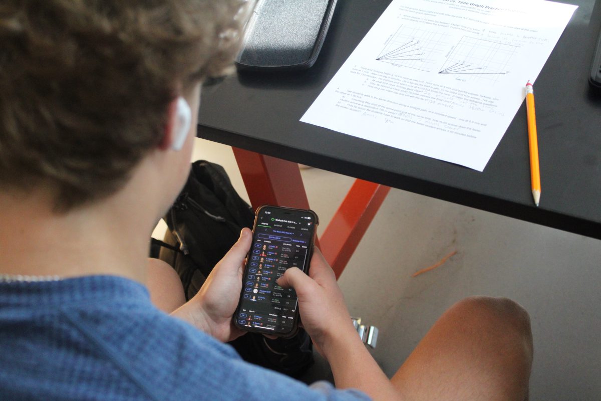 Senior Brennan Hogan sets his fantasy football lineup during class time. Fantasy football is a platform that allows participants to coach a digital football team.