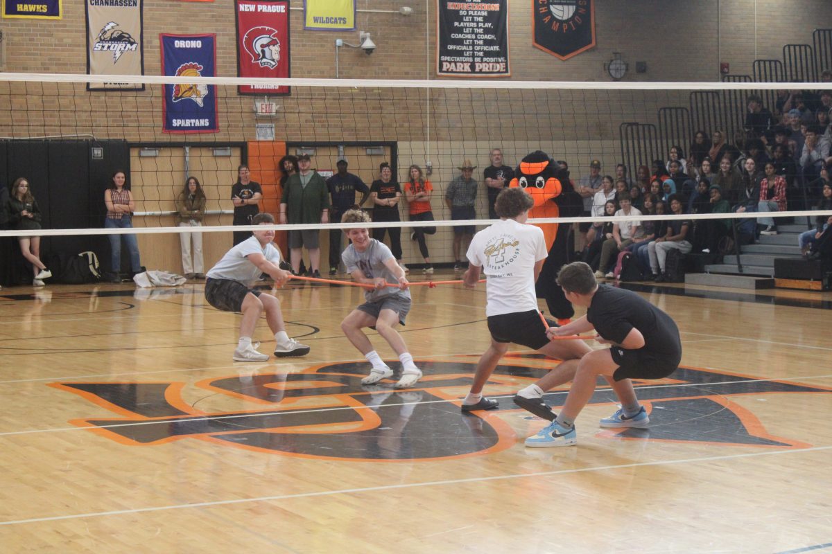 Senior Sam Tolzin and Sophomore Finn Shepard compete in a game of tug of war during the pep fest Sep.18. The pep fest is held yearly to show school spirit during homecoming week.