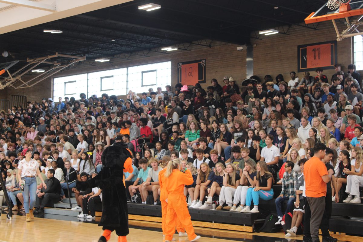 Juniors Destiny Bogza and Maggie Tight get the energy up at Park’s homecoming pepfest on Sept. 18. The pepfest activities included tug of war and a staff vs. students volleyball game.