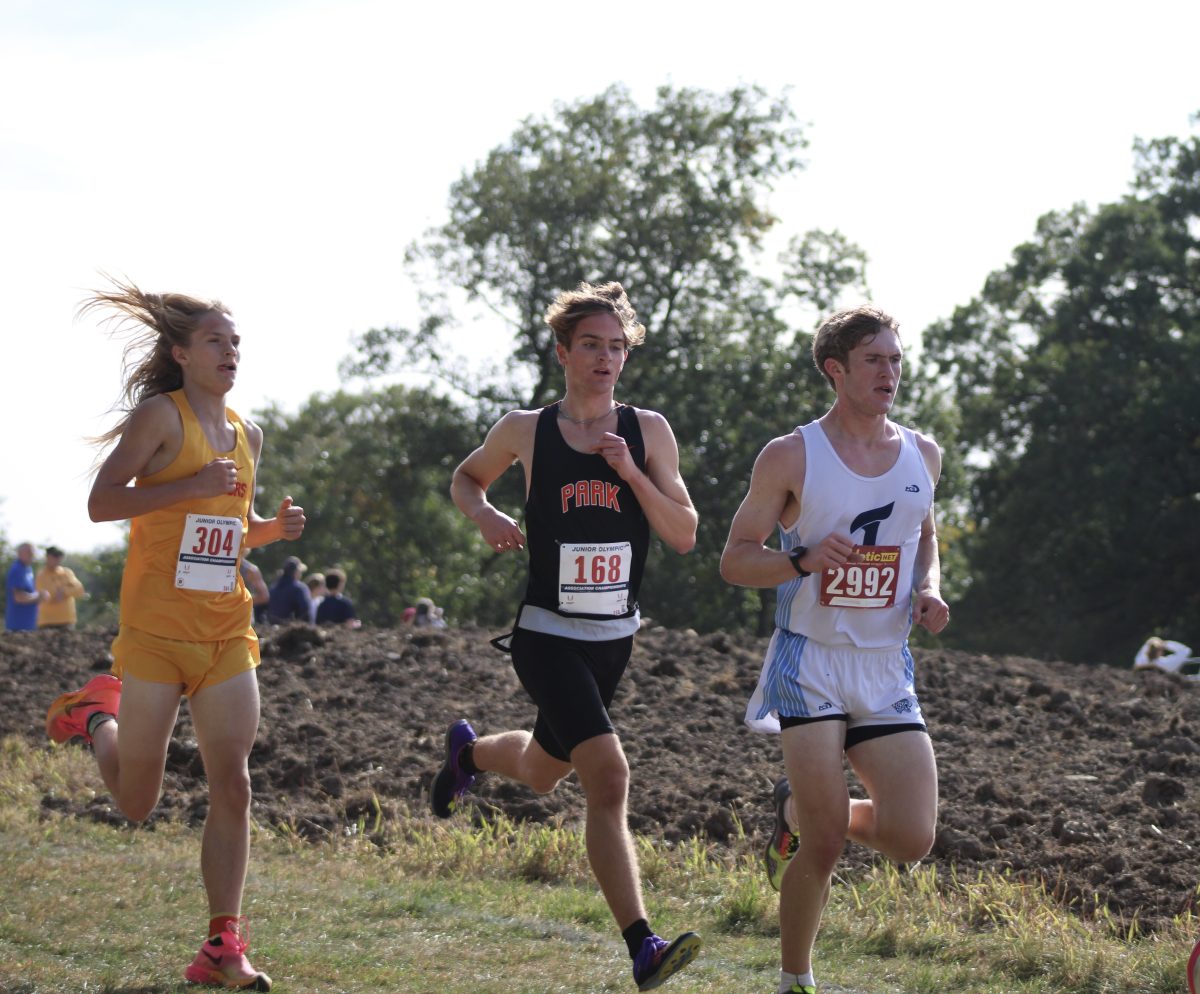 Senior Paxon Myers flies down the hills on the way to the finish line. Boys cross country competed Oct. 1 at Gale Woods.