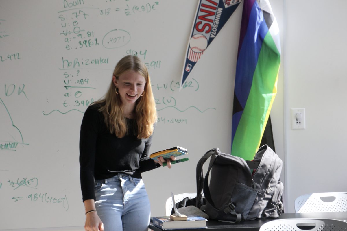 Senior Sylvia Tolzin works on an assignment in the newly remodeled A3 hallway Oct. 7. She utilizes the newly installed whiteboards to calculate and coordinate with her team.