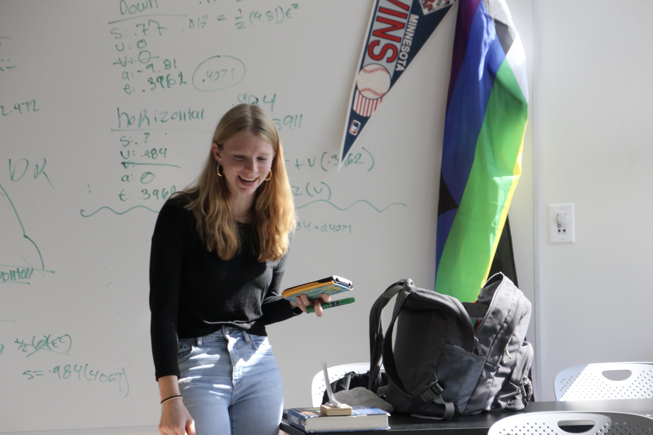 Senior Silvia Tolzin works on an assignment in the newly remodeled A3 hallway Oct. 7. She utilizes the newly installed whiteboards to calculate and coordinate with her team.