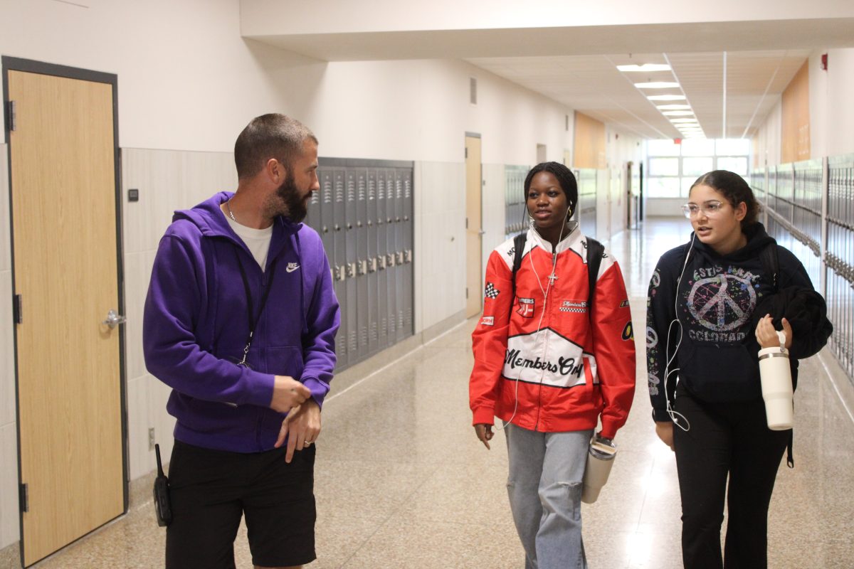 Achievement & Support Coordinator, (ASC) Chris Nordstrom, checks in with students in the hallway Oct. 10. He has worked closely with the implementation of SmartPass at Park.