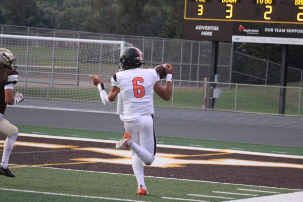 Sophomore Everett Arnold runs ball into the end zone, scoring a touchdown Sept. 13. Arnold currently has 746 throwing yards. 