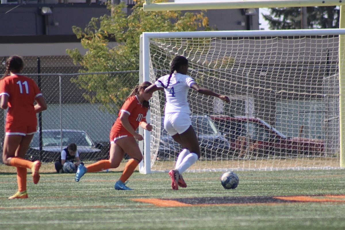 Senior Anna Williams defends attacker from dribbling the past her Park played Washburn and lost 3-1 on Oct. 5.