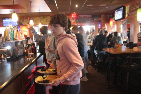 Park boys’ hockey team hosts a “Pancakes for Pucks” fundraiser. Brian Duncan serves customers at Applebee's Oct. 26.