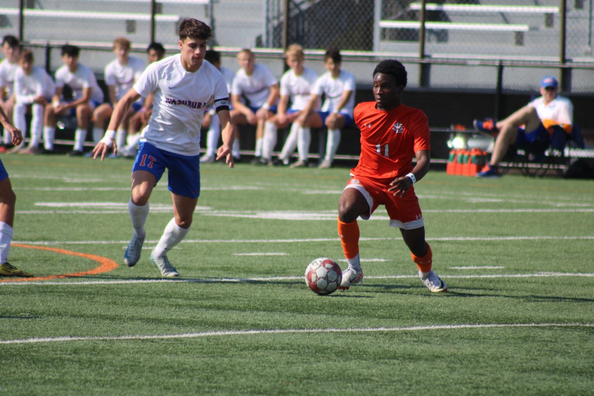 Senior Gael Miteo dribbles the ball around a Wasburn player Oct. 5. Park tied 2-2 to Washburn.