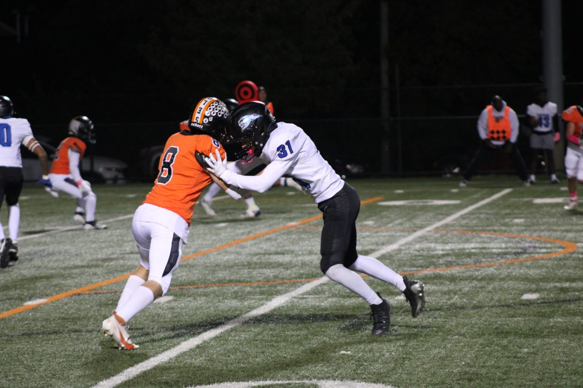 Senior Sam Tolzin blocks Tartan player Oct. 4. The Orioles won 24-21 at home.