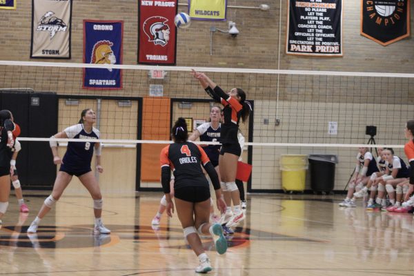 Senior Amara Schroeder sets the ball for Neveah Carlson to spike over the net Oct. 7. Park wins 3-0 against Mahtomedi.