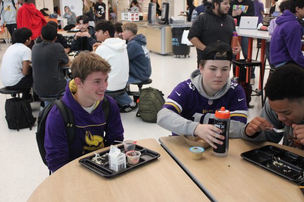 Sophomores Aaron Tix and Lucas Dearking sport their Vikings apparel during lunch Oct. 24. Many students and staff at Park wear their Vikings gear to school to show support for the team.