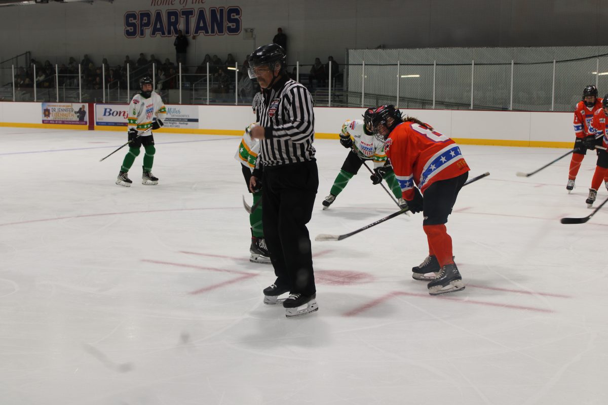 Hockey referee prepares for a face off Oct. 26. A referee shortage has impacted Park for the past couple of years.