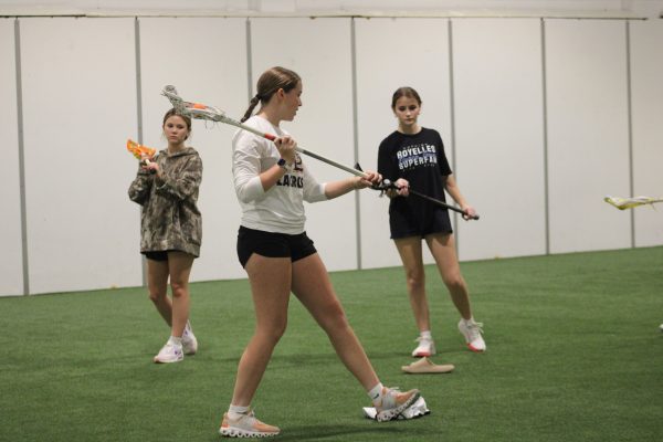 Senior captain Ashley Berry demonstrates shooting to new players Nov. 11. Captain's practices are held every Monday at Pipeline Lacrosse Home Turf.