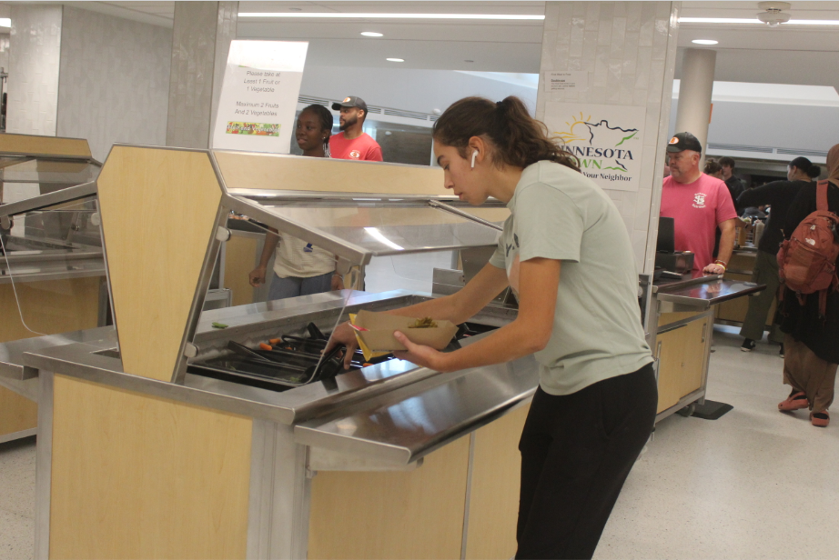 Senior Ale Coronado gets lunch after waiting in the long lunch line Oct. 29. Many students have reported they have less time to eat and socialize due to the long lines.