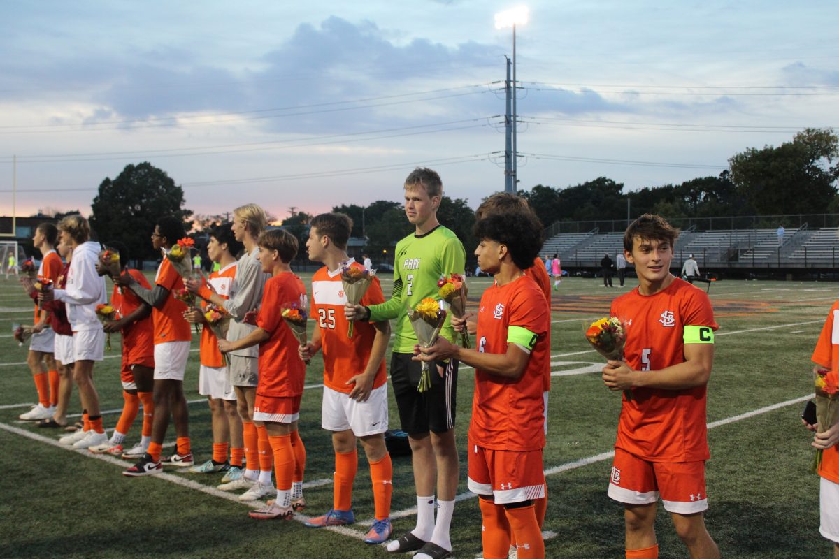 Senior boys' soccer players stand for senior night ceremony Oct. 1. Every season, seniors are celebrated for their commitment to their sport with a ceremony dedicated to them.