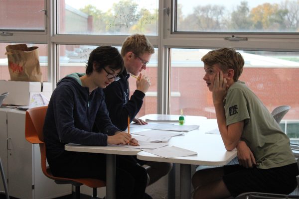 Seniors Jude Sadovsky, Ian Bautista and Thomas Smith work on IB HL Analysis and Calculus BC homework Oct. 30. Many students have opted to take the Calculus BC test independently.