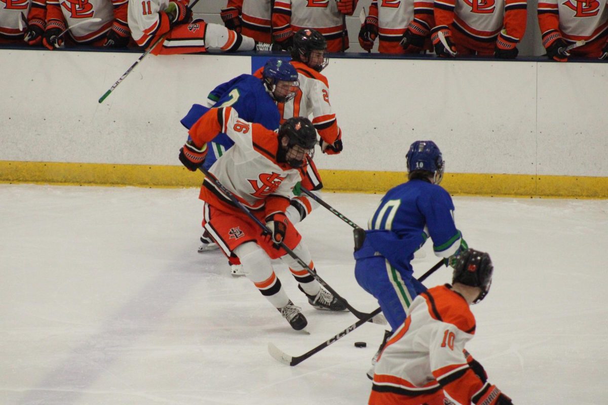 Senior and left wing Tyler Hess skates the puck up the side of the rink. Park ended up losing 4-2 against the Blake Bears Dec.10.