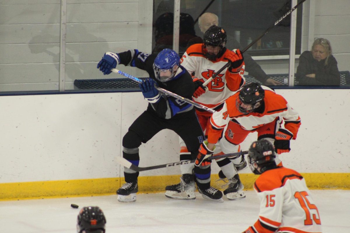 Senior defensemen Hayden Kasica and sophomore right wing Liam McCoy stopped the Hopkins player before he got to the goal Dec. 5. Park won 8-1 against their rival, the Hopkins Royals.