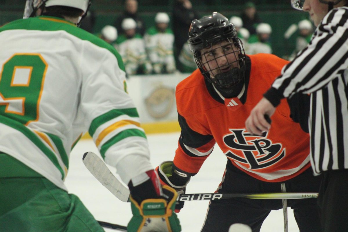 Senior center Louie Piper sets up in a face-off against Edina's center Dec. 14. Park loses 7-1 against the Edina Hornets.