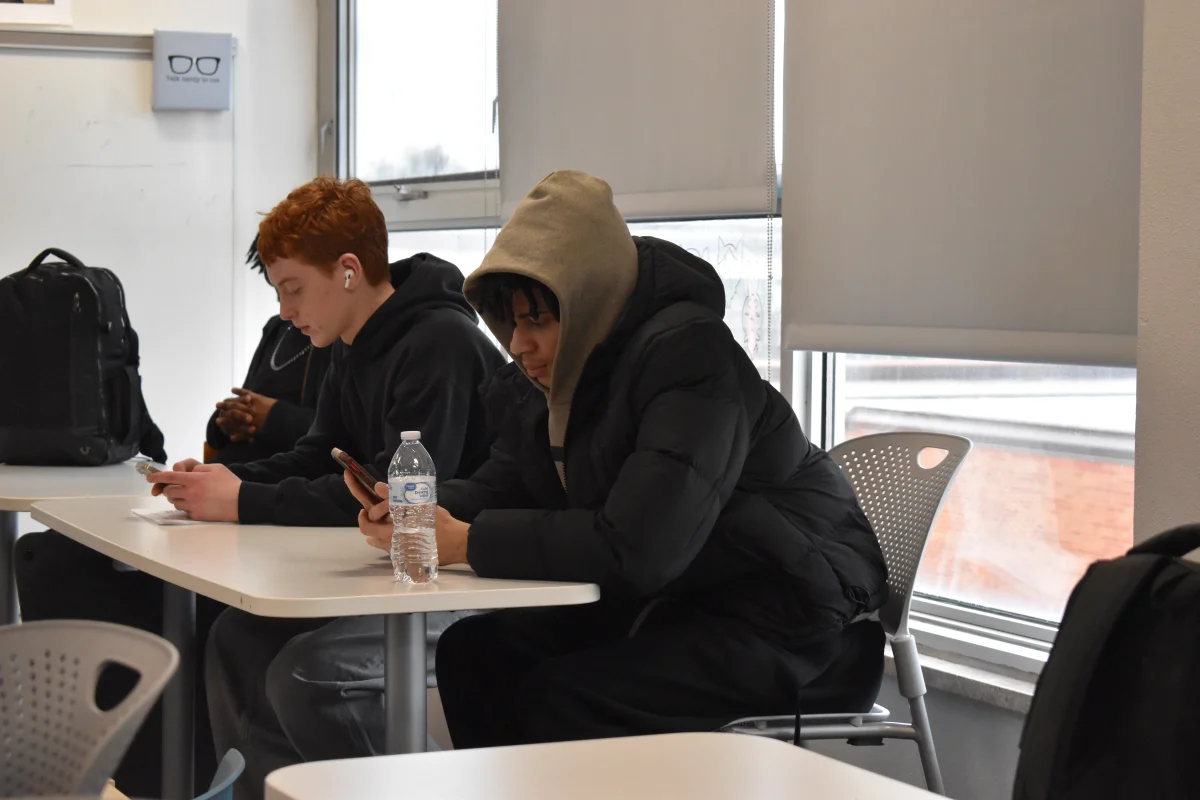 Senior Drevon Gillard and junior Brennan Healy use their phones during class Feb. 24. Park's cell phone policy works to limit distraction in classrooms through restricting phone usage.