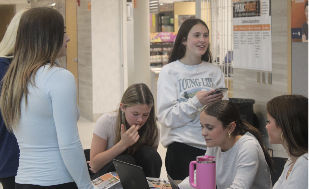 Senior Sarah Tirado looks up a student in her computer May 21. Echowan spends the year creating a yearbook.