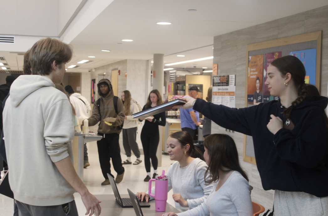 Junior Ivy Hoeschen hands out a yearbook May 21. Echowan sold around 600 yearbooks this 2024-2025 school year.