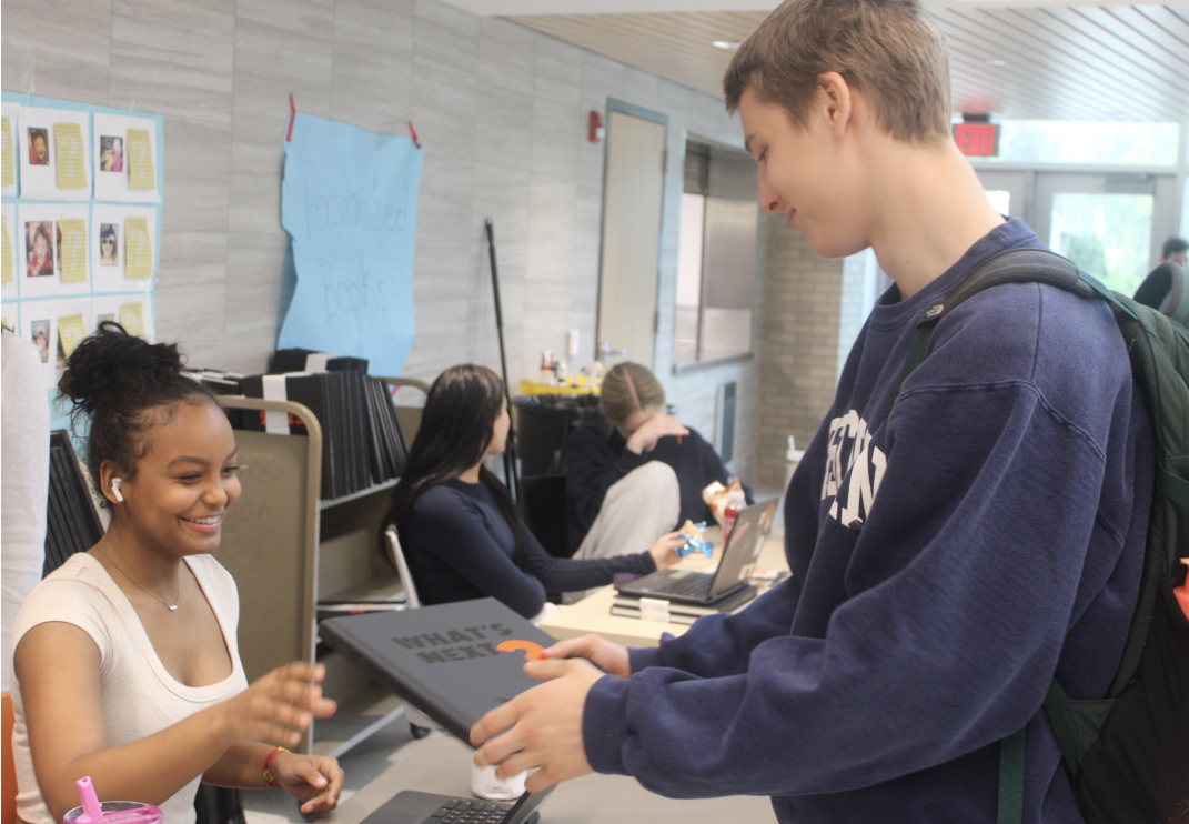 Sophomore Colin Faust examines a yearbook May 21. Students can be featured in the yearbook for sports and extracurriculars.