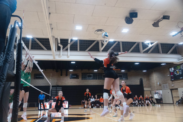 Junior captain Celia Slattengren goes up for a hit against a block Oct. 22. The Orioles played against Edina’s Hornets, losing 3-1 in their first-round sectional game.