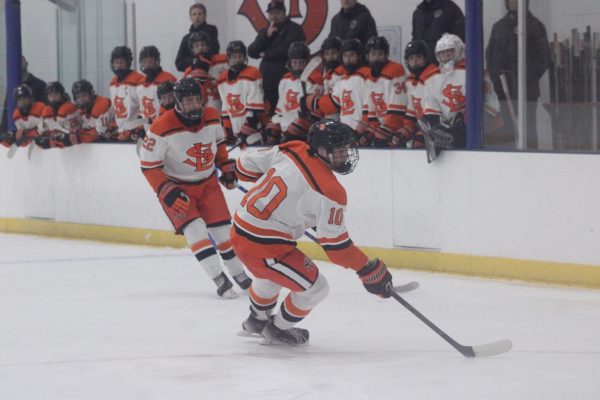 Junior Leo Schmoll protects the puck alongside junior Nicky Moran against the Armstrong Cooper Wings Nov. 21st. Park ended with a score of 6-5, kicking off their first win of the season.  