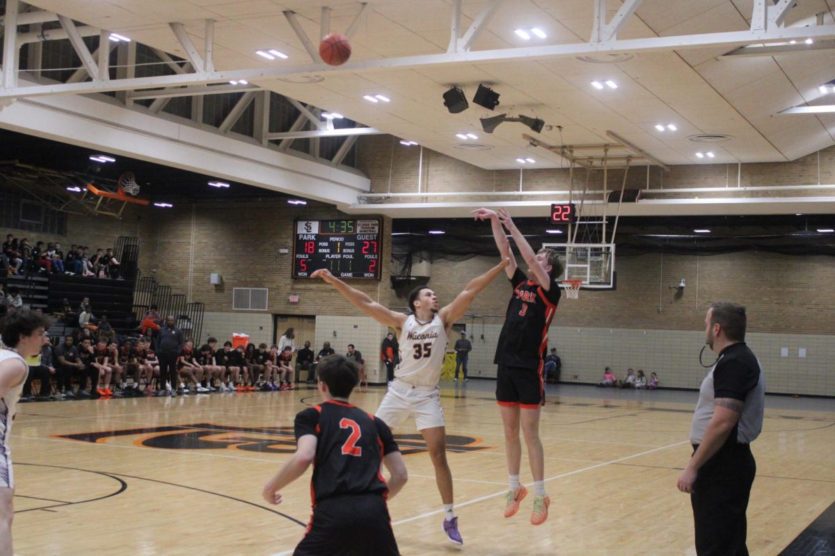 Senior Jaxson McDonnell shoots a fade-away on a Waconia Wildcat defender Jan. 15. The game ended in a loss for Park with a final score of 87-59.