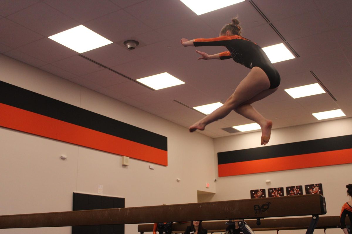 Junior Tesa Allie performs a wolf jump on her beam routine Jan. 22. Park went up against Breck, losing 138.25-133.3.