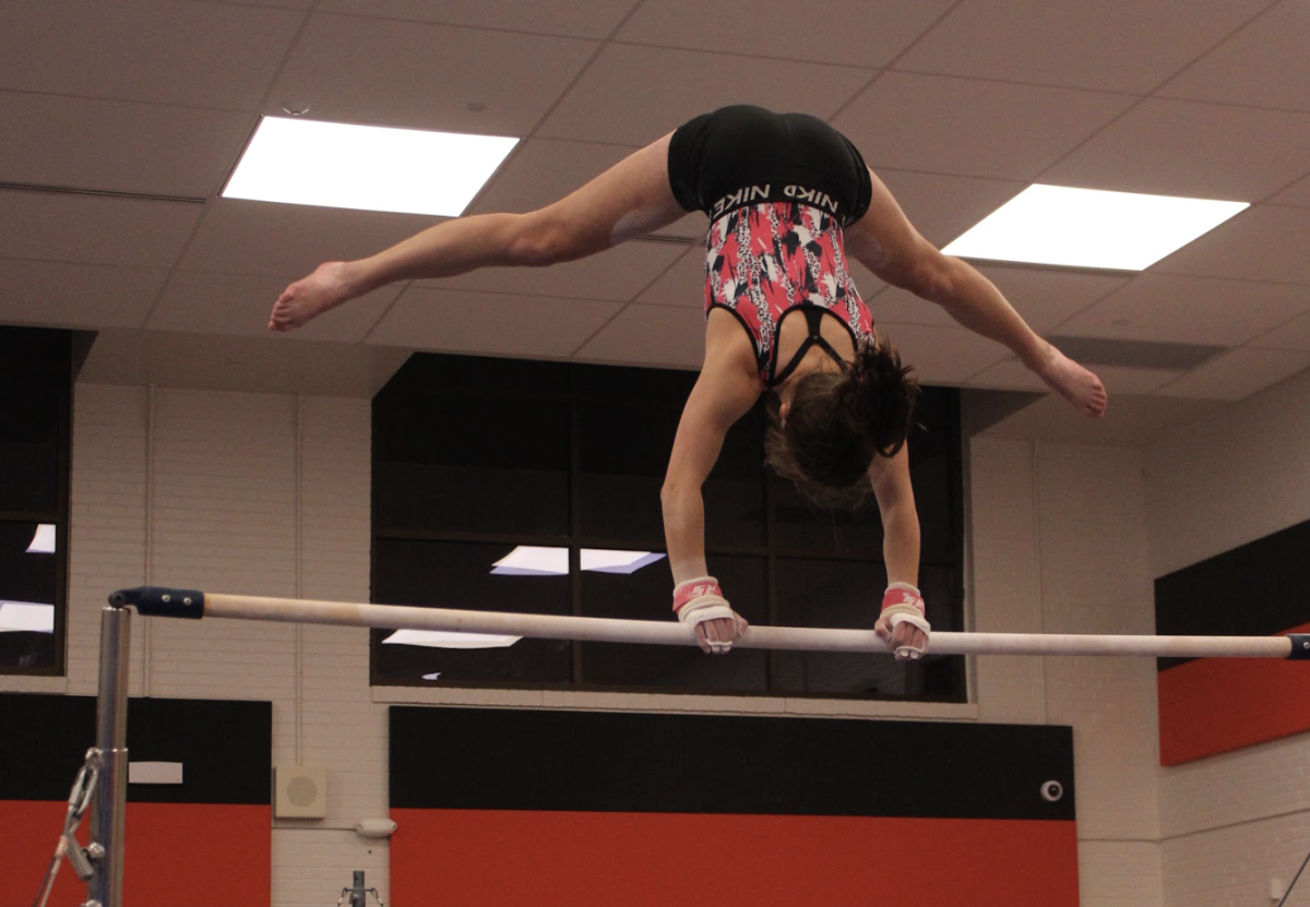 Senior captain Veronica Jones practices her bar skills at gymnastics practice Dec. 3. A second bar set was one of the additions of the new gymnastics gym.