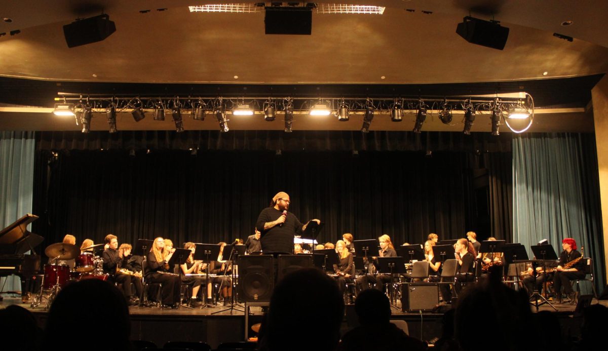 Band Director Dan Anderson introduces the full band to the audience March 10. He explains the theme of the concert, video game soundtracks, which was chosen by the students.