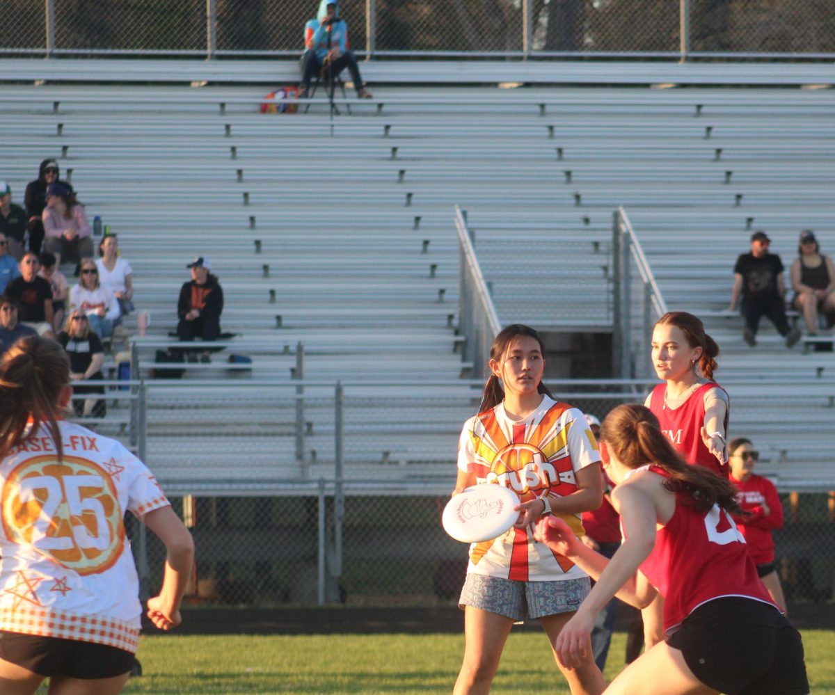 Junior team captain Tenzin Pedon prepares to pass the frisbee to a teammate April 21. The girls and nonbinary frisbee team lost 15-6 to BSM.