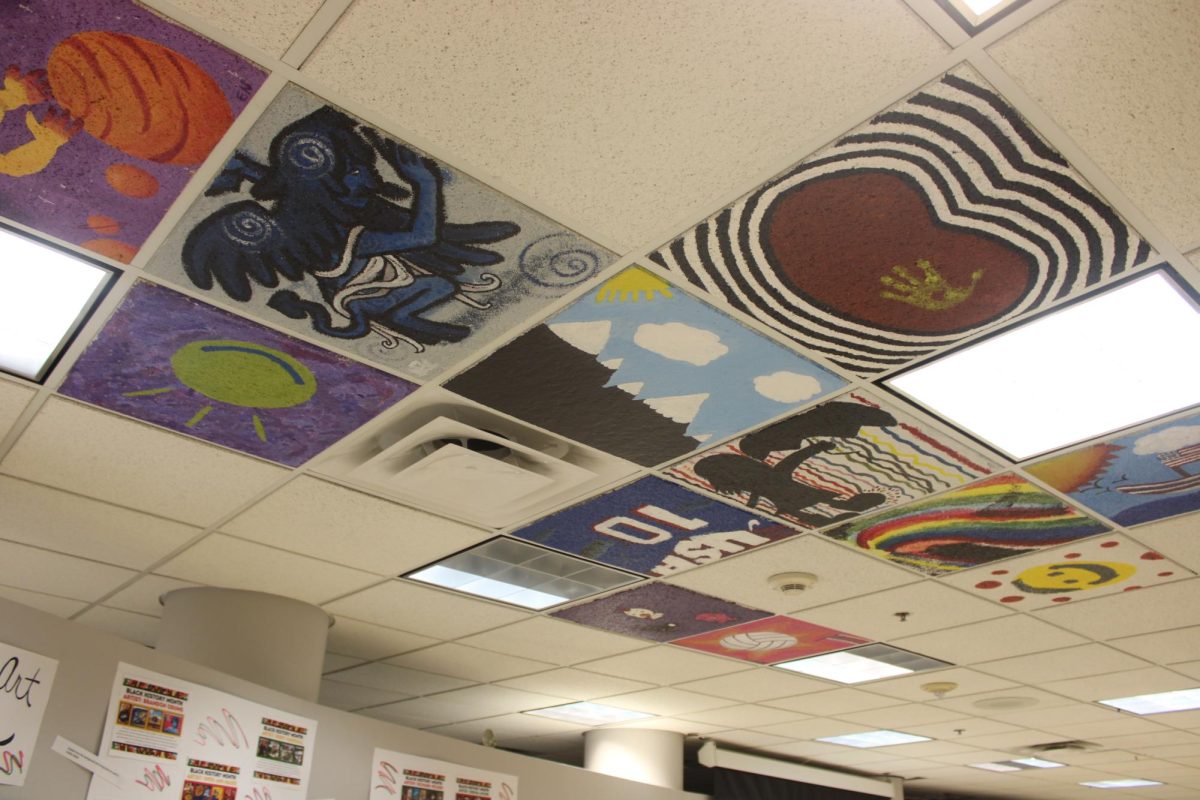 Ceiling tiles and other art work displayed in Ms. Timmerman’s classroom. Art is another way that students can show their intelligence.
