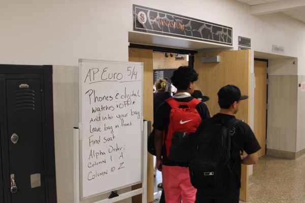 Students get ready to take their Advanced Placement European history test April 4. Testing rooms display the several strict rules the students must follow on white boards for students to pass as they enter.