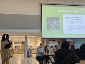 Senior Rahmah Davis presents the design idea for the annual senior tradition of painting a wall May 13. The design was made by Davis alongside seniors Ari Pascual and Kamaria Austin and will reflect a “Pretty Little Birds” by SZA theme.