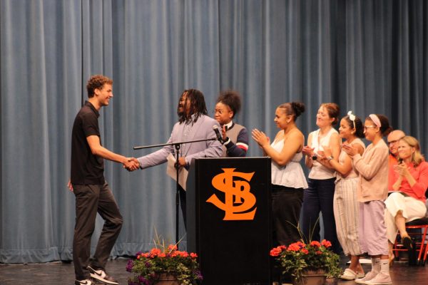 Jacob Natzel accepts his scholarship at the Dollars for Scholars event May 20. The Dollars for Scholars program provides students with choice scholarships and offers one last bit of assistance in their future.