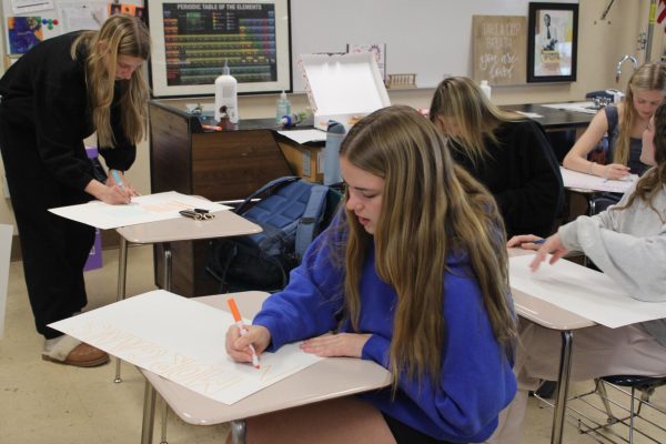 Junior Lola Grimm creates a poster promoting mental health awareness for a sports event April 15. Morgan’s Message uses posters to bring attention to the importance of mental health for athletes.
