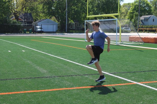 Junior Aaron Tix warms up for practice on the Park track May 15. As a rookie, he has been slowly climbing the ranks of the track team, earning a spot on varsity.
