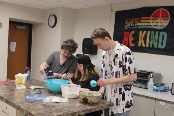 Transition Plus students Clayton Carlson, Katie Taylor and Creech Unger work on a baking recipe March 26. The program enables students to practice valuable life skills, such as cooking, cleaning and financial skills.