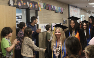 Seniors Margret Tight and Asa Bomsta begin their senior walk at Park Spanish Immersion May 29. The senior walk is an annual tradition during which the graduates return to their elementary schools to be celebrated.