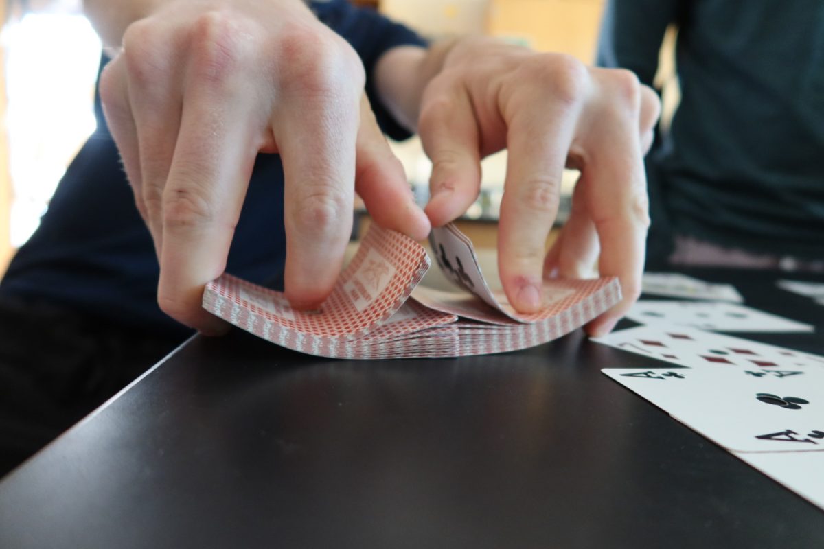 A student shuffles a deck of cards on a science classroom table on May 6. Students' gambling at the Park has been on the rise, sparking a crackdown on the rules in school.